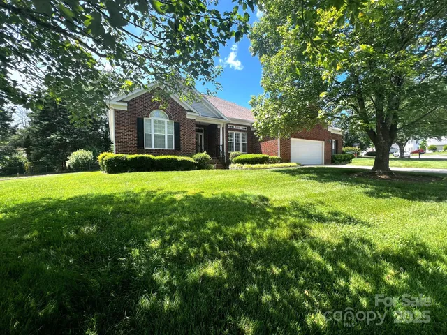 a front view of a house with yard and green space