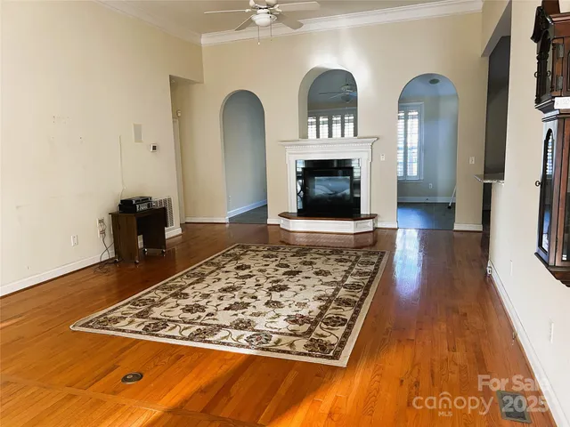 a living room with fireplace furniture and a rug