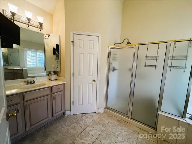 a bathroom with a double vanity sink and mirror