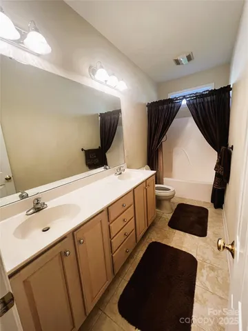 a bathroom with a double vanity sink and mirror