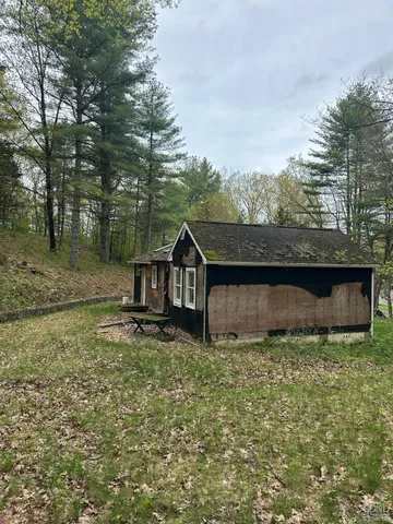 a view of a tiny house with a yard