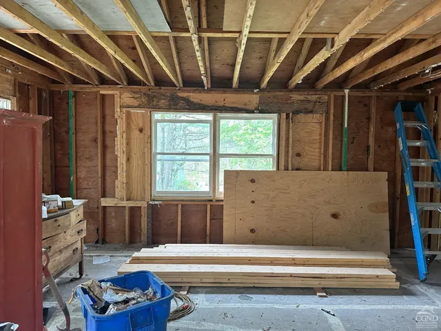 a bedroom with furniture and a window