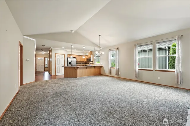 a view of an empty room with a kitchen