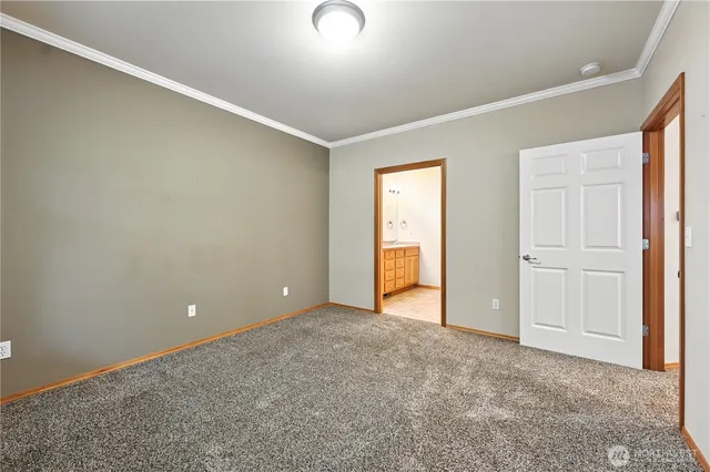 an empty room with closet and windows