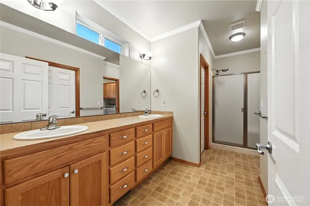 a spacious bathroom with a double vanity sink mirror and double