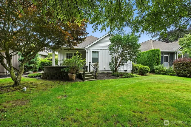 a view of a house with backyard sitting area and garden