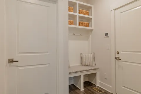 a view of an entryway with wooden floor