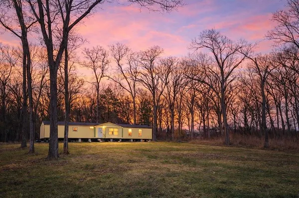 a backyard of a house with lots of green space and fountain