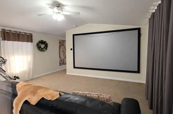 a living room with furniture and a air conditioner vent