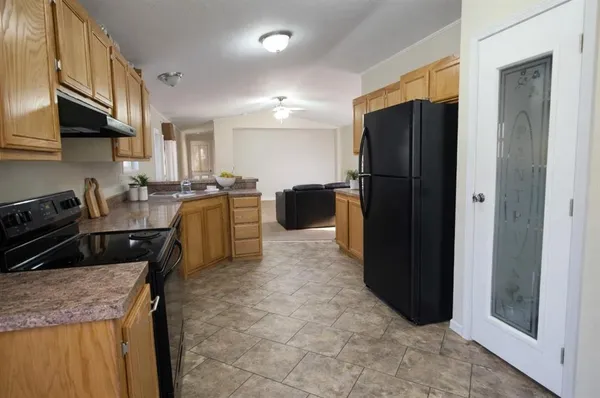 a bedroom with a bed and lamp on desk
