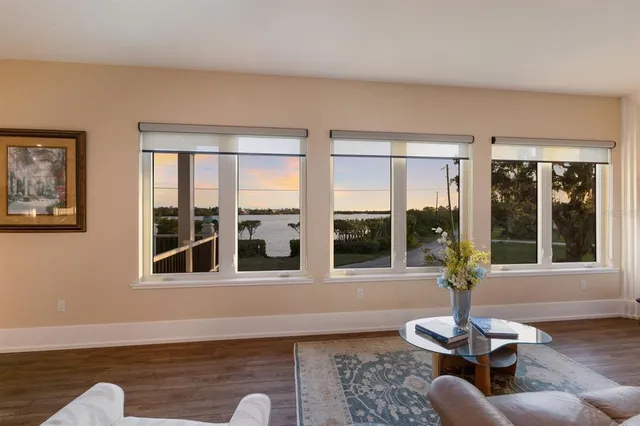 a living room with furniture fireplace and a large window