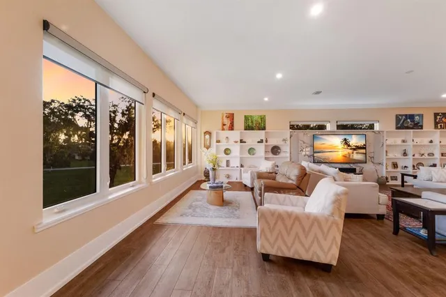 a living room with furniture and a view of kitchen