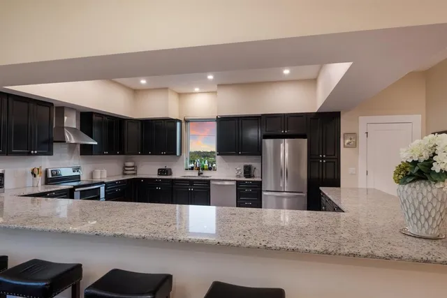 a kitchen with wooden cabinets and black stainless steel appliances