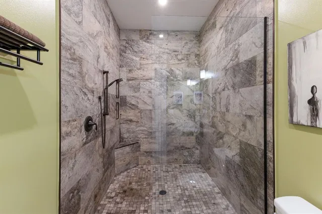 a bathroom with a toilet and a shower curtain