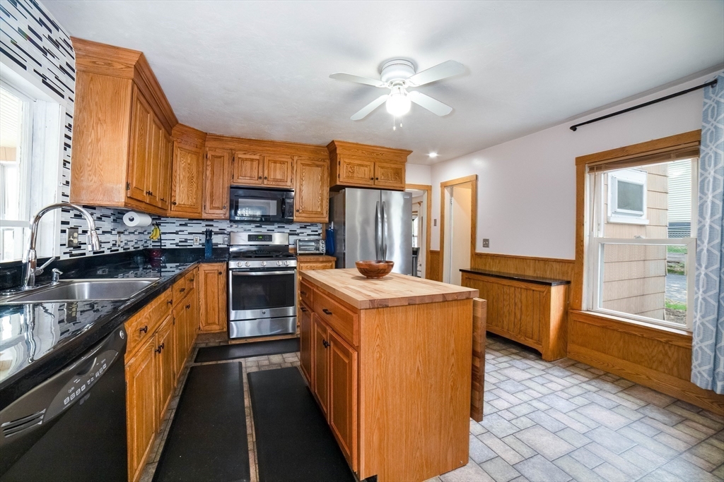 4 Brown Street Spencer, MA 01562 - Photo 11 of 34 a kitchen with a stove a sink and a refrigerator