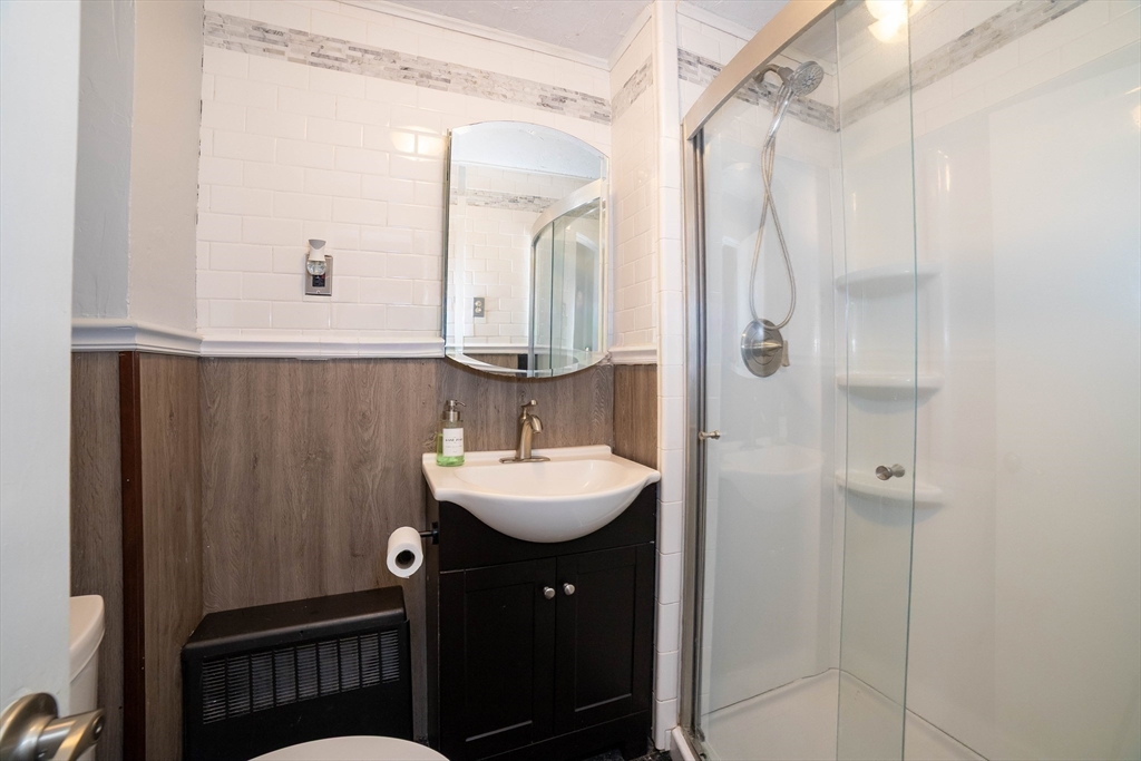 4 Brown Street Spencer, MA 01562 - Photo 13 of 34 a bathroom with a sink a mirror a vanity and shower