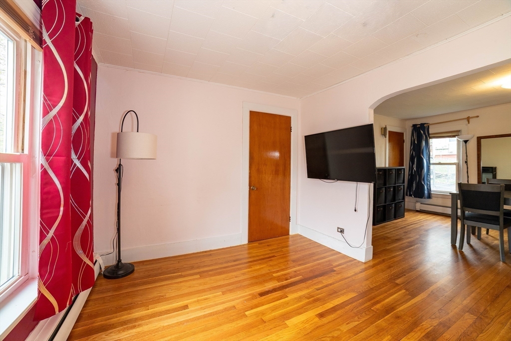 4 Brown Street Spencer, MA 01562 - Photo 3 of 34 a view of a livingroom with wooden floor and a flat screen tv