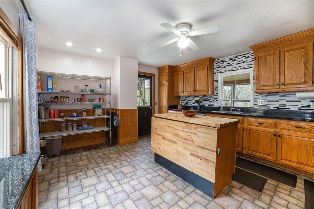 4 Brown Street Spencer, MA 01562 - Photo 8 of 34 a kitchen with stainless steel appliances granite countertop a refrigerator and a stove top oven