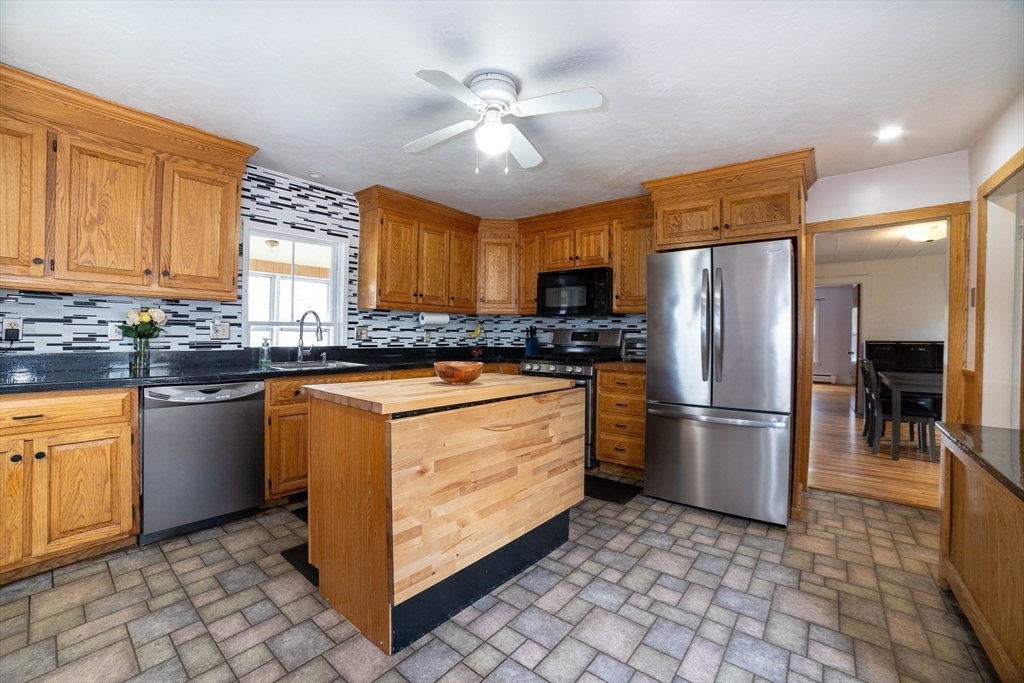 4 Brown Street Spencer, MA 01562 - Photo 9 of 34 a kitchen with stainless steel appliances granite countertop a refrigerator a sink a stove a washer and dryer