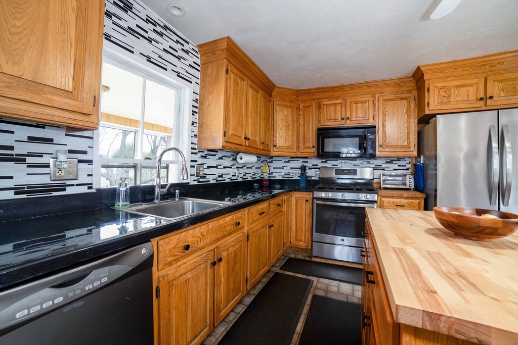 4 Brown Street Spencer, MA 01562 - Photo 10 of 34 a kitchen with stainless steel appliances a stove sink microwave and cabinets