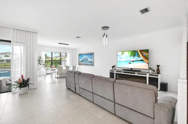 a dining room with furniture and a large window