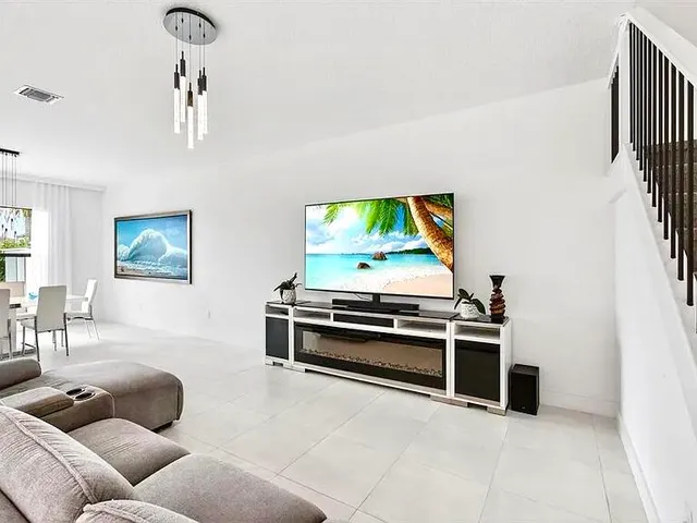 a kitchen with granite countertop a white stove top oven and cabinets