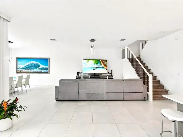 a kitchen with stainless steel appliances kitchen island granite countertop a refrigerator and a sink