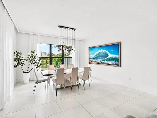 a kitchen with a refrigerator and white cabinets