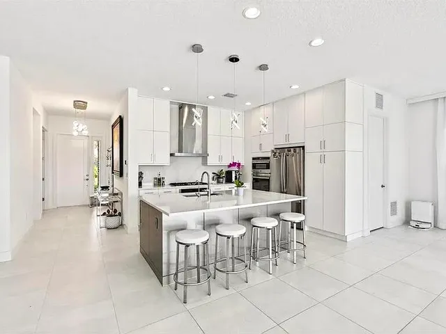 a living room with furniture a flat screen tv and a large window