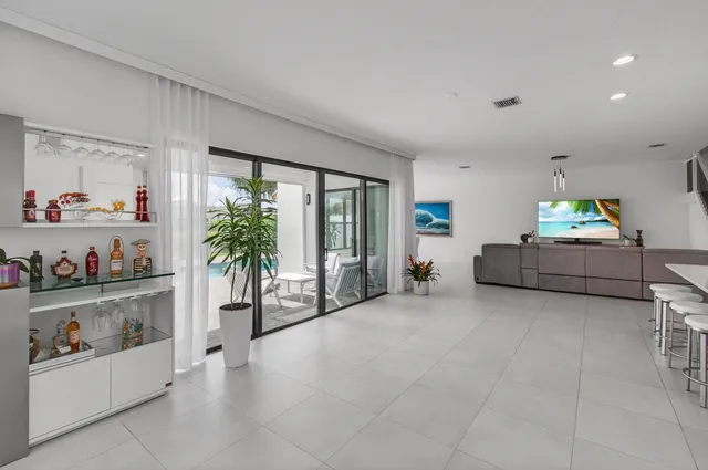 a bed room with a bed mirror and a large window