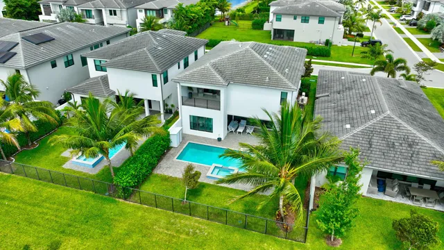 an aerial view of residential houses with outdoor space and street view