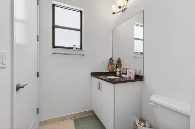 a kitchen with stainless steel appliances granite countertop a sink and a stove