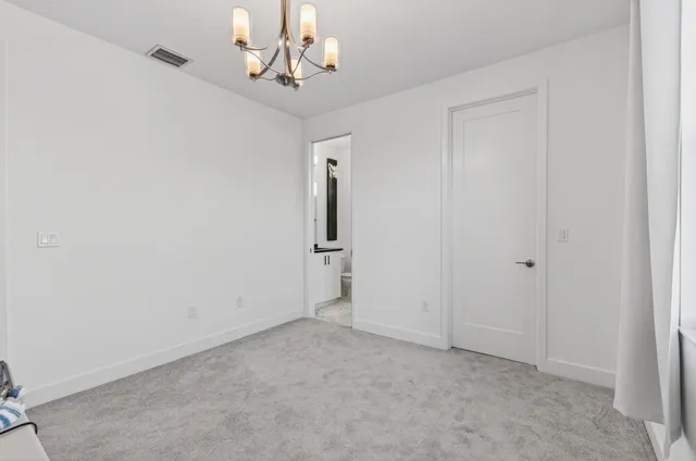 a living room with patio furniture and a floor to ceiling window