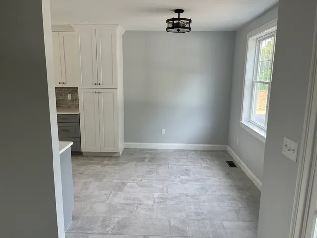 a view of a livingroom with wooden floor and stairs