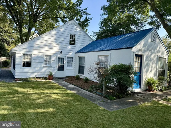 a view of a house with a patio and a yard