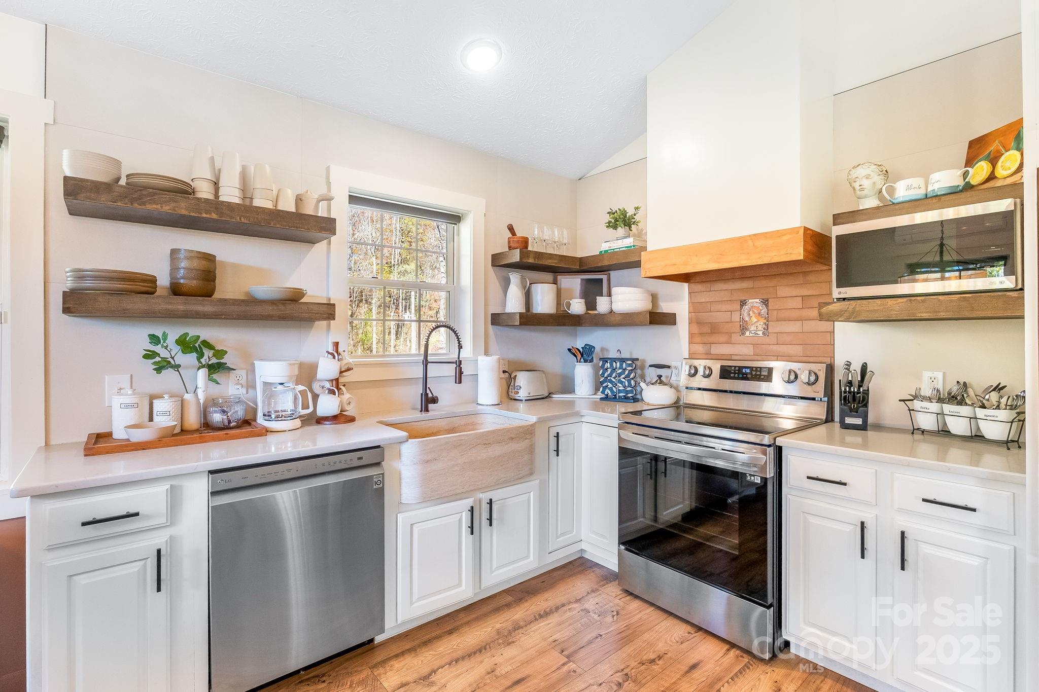 146 Promiseland Road Canton, NC 28716 - Photo 14 of 30 a kitchen with a stove sink and cabinets