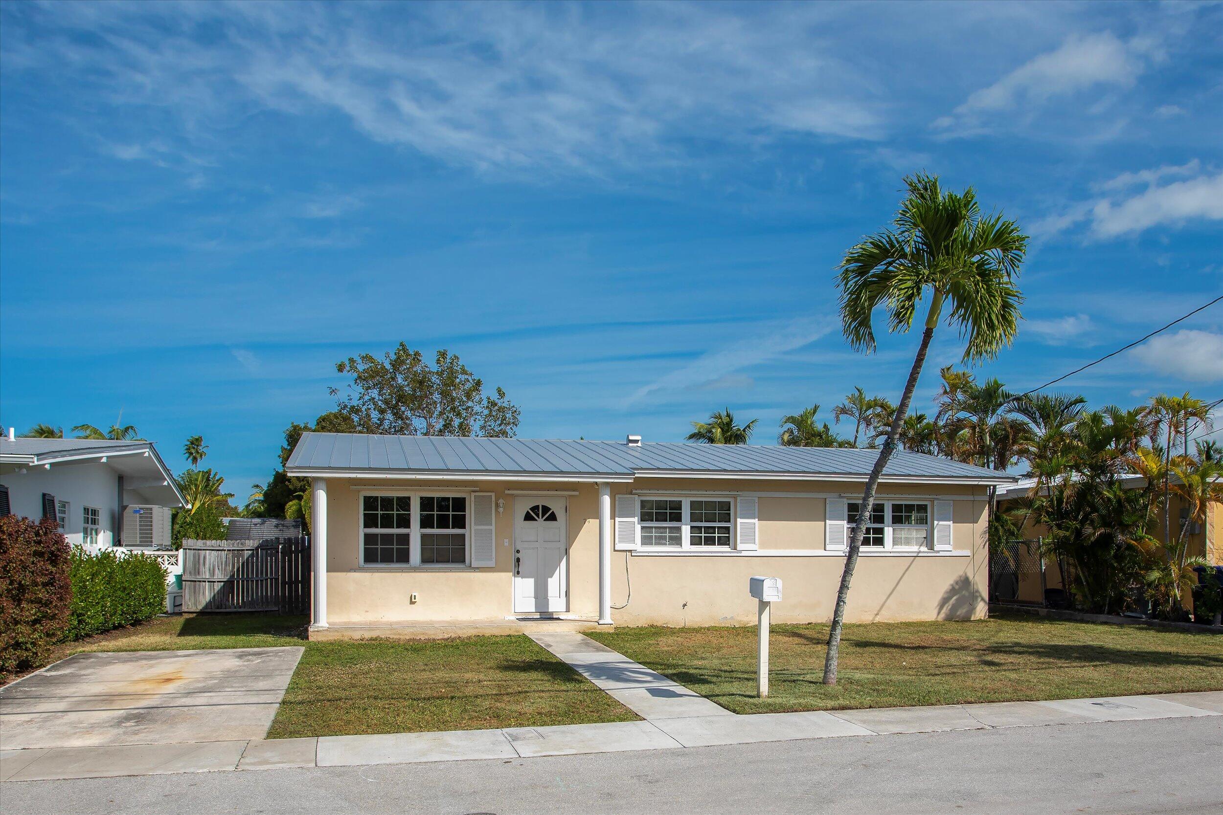 74 Key Haven Road Key West, FL 33040 - Photo 1 of 28 a front view of a house with a yard and garage