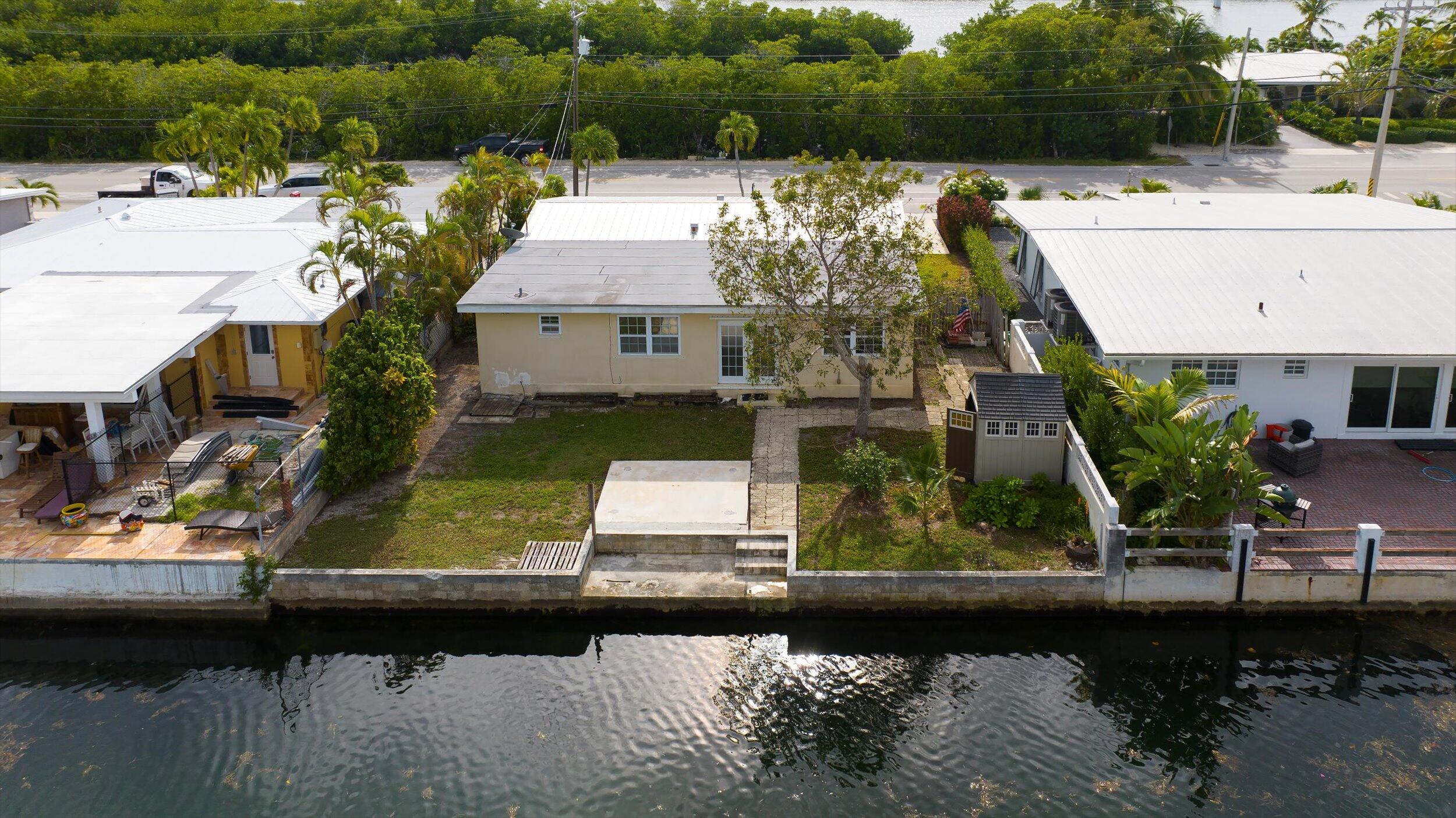 74 Key Haven Road Key West, FL 33040 - Photo 23 of 28 a view of a house with pool and a lake view