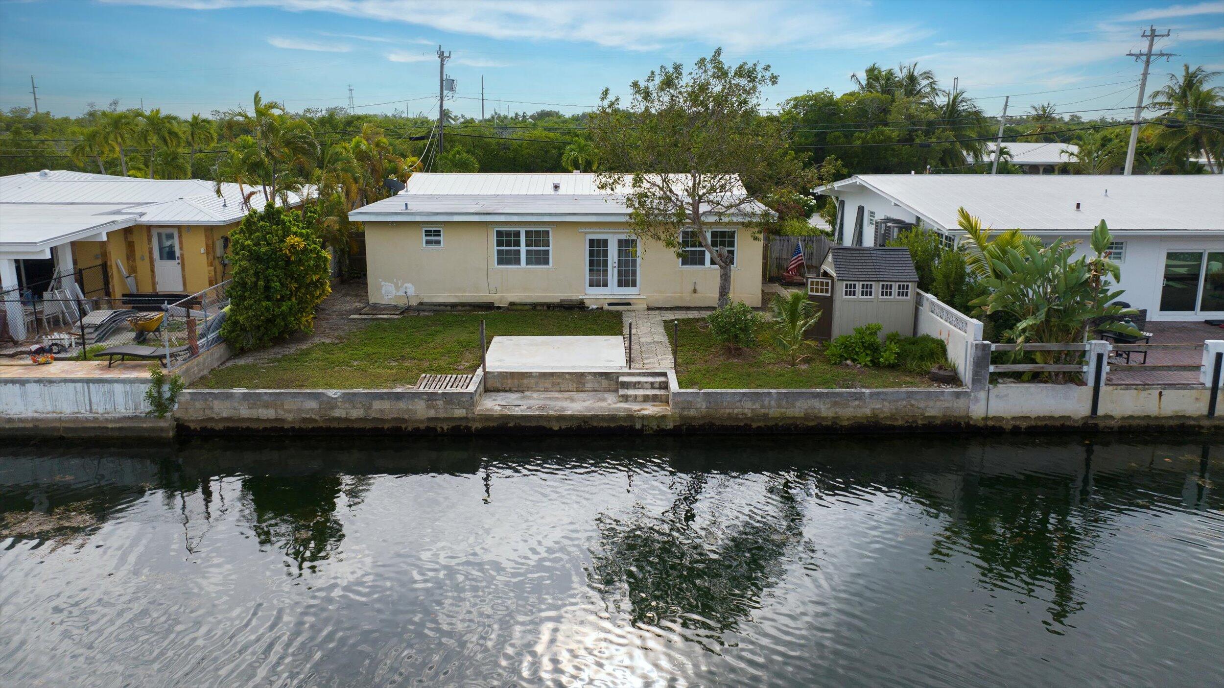 74 Key Haven Road Key West, FL 33040 - Photo 26 of 28 a view of a lake with a yard and potted plants