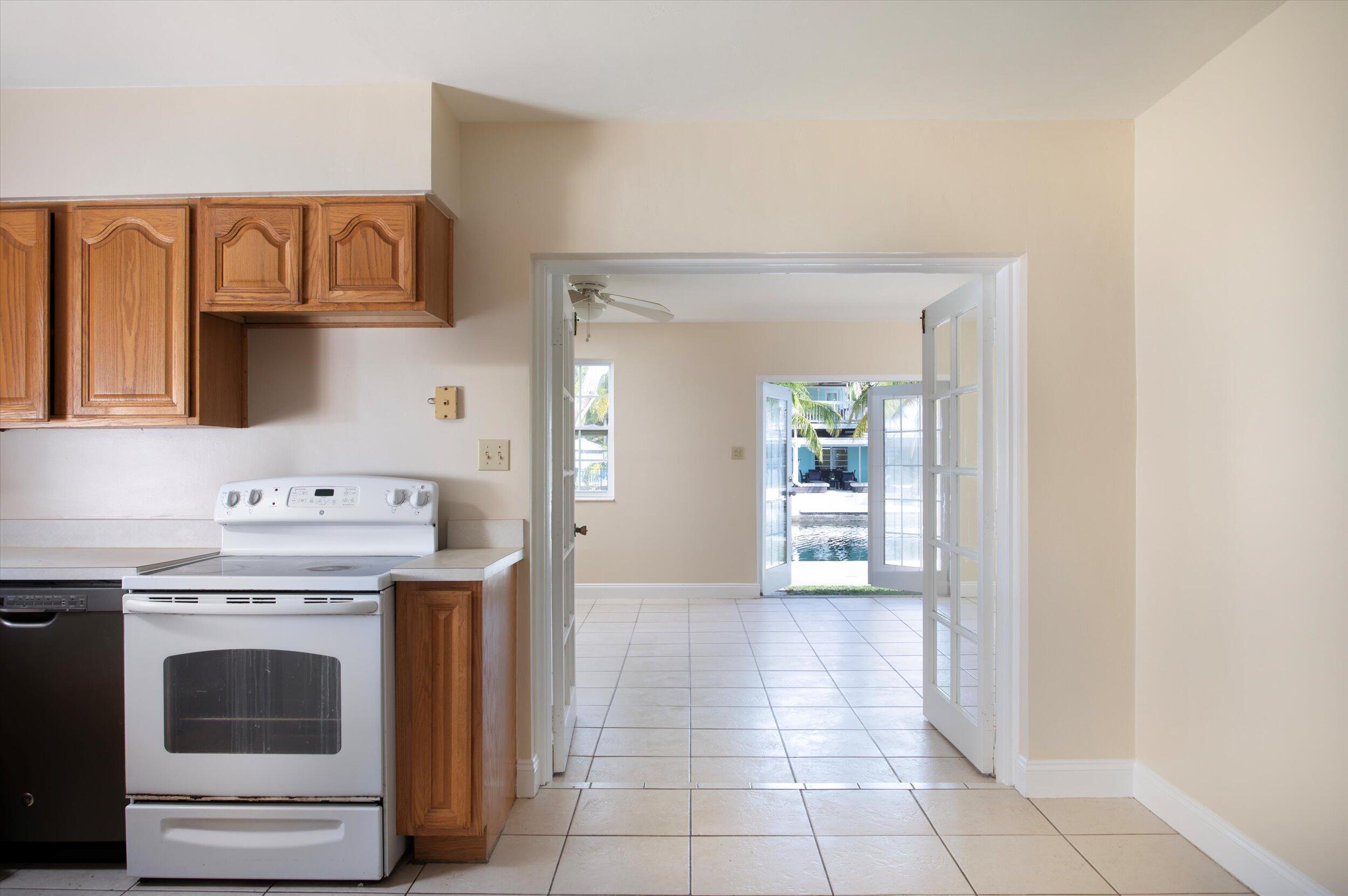 74 Key Haven Road Key West, FL 33040 - Photo 5 of 28 a kitchen with a stove top oven and cabinets