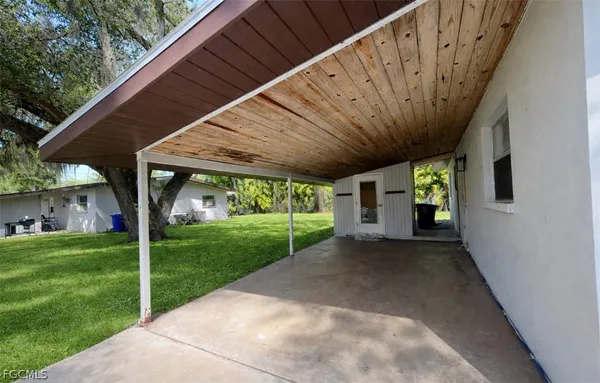 a view of a porch with furniture and garden
