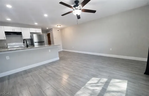 a view of kitchen with refrigerator microwave and stove