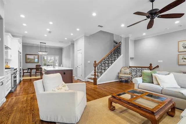 a living room with furniture and wooden floor