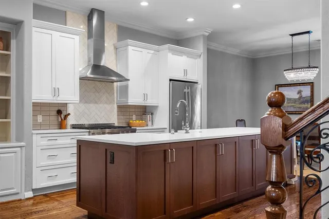 a kitchen with a stove a refrigerator and cabinets