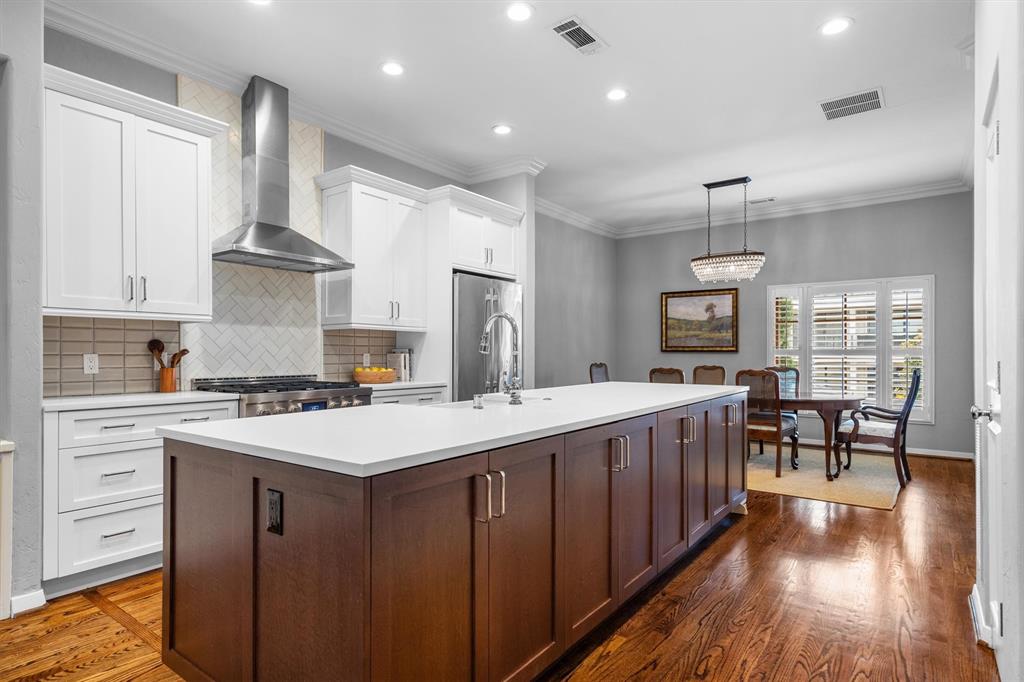 4323 Gilbert Avenue, Unit 4 Dallas, TX 75219 - Photo 15 of 40 a kitchen with a stove and wooden floor