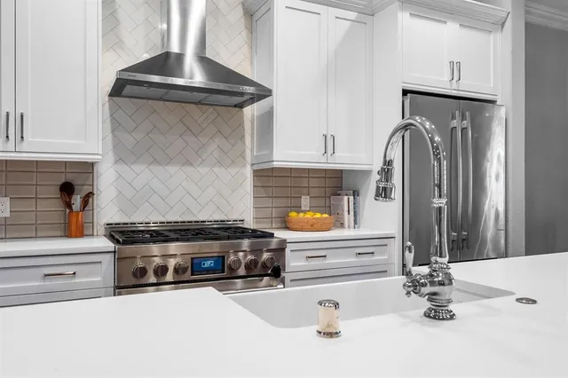 a kitchen with stainless steel appliances granite countertop a sink and cabinets