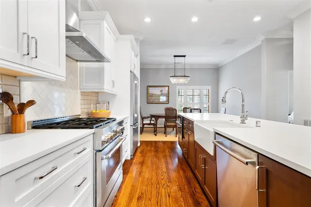 a kitchen with sink stove and cabinets