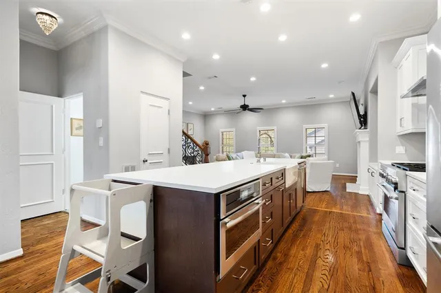 a large kitchen with stainless steel appliances a stove a sink dishwasher and a refrigerator