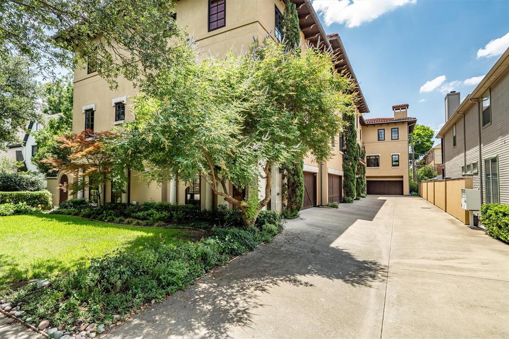 4323 Gilbert Avenue, Unit 4 Dallas, TX 75219 - Photo 2 of 40 a view of a white house next to a yard with plants and trees