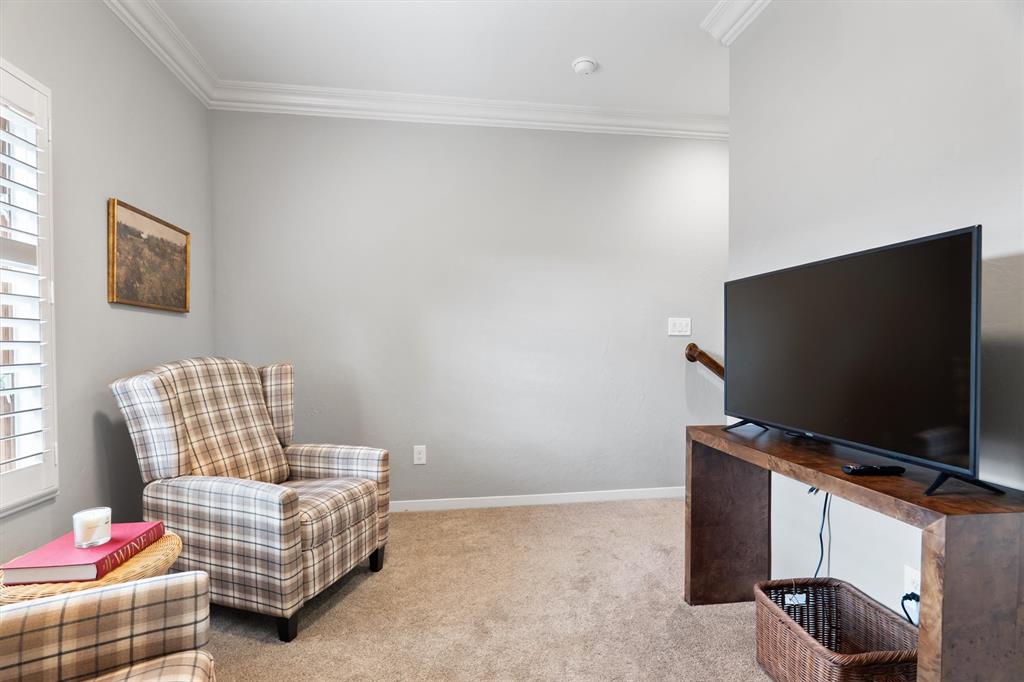 4323 Gilbert Avenue, Unit 4 Dallas, TX 75219 - Photo 25 of 40 a living room with furniture and a flat screen tv